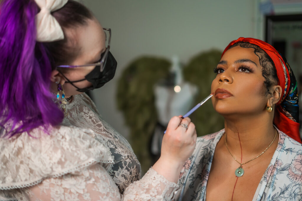 A woman gets her makeup professional done at the rochester new york boudoir studio.