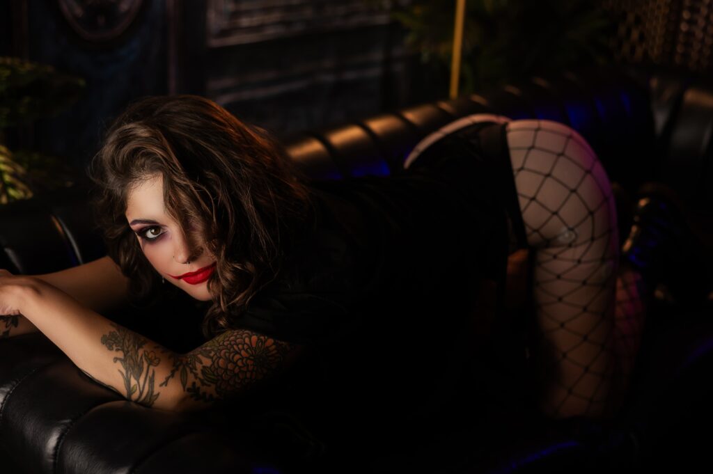 Halloween boudoir portrait in Rochester, NY, showcasing a luxurious and intimate bedroom setting